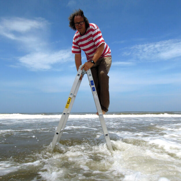 Artist Jacques Coetzer suspended over the warm waters of Durban , South Africa , December 2, 2011